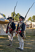 Two men in Revolutionary War uniforms as honor guards for the flag ceremony, Fort Bridger Rendezvous, Wyoming.