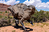 Life-size replica of the dinosaur Iguanodon bernissartensis the Moab Giants dinosaur park in Moab, Utah. It is being attacked by a Deinonychus antirrhopus, a medium-sized raptor dinosaur.