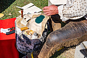 A man in period mountain man dress shows how to make leather Native American moccasins at the Fort Bridger Rendezvous in Wyoming.