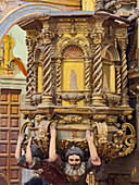 The carved wooden pulpit in the nave in the Church of San Francisco in the historic center of Quito, Ecuador.