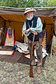An older man in period dress with his muzzle-loader rifle at the Fort Bridger Mountain Man Rendezvous in Wyoming.