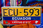 A souvenir license plate from Ecuador for sale in the market in Otavalo, Ecuador.