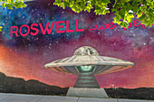 A painted mural of an alien space craft on the side of a building in Roswell, New Mexico.