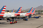 Ground crews move baggage for the airliners at Phoenix Sky Harbor Airport, Phoenix, Arizona.