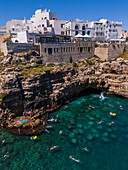 Aerial view of people enjoying the clear waters of Polignano a Mare, Puglia, Italy