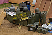 A stall in street market with war helmets, ammunition boxes and gasoline cans, Navacerrada, Spain