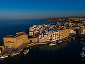 Aerial view of Porto Antico, the historic old port, the Marina, Castello Carlo V and the old town, Monopoli, Italy