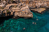 Aerial view of people enjoying the clear waters of Polignano a Mare, Puglia, Italy