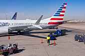 An aircraft marshaller directs an airliner into the gate at Sky Harbor International Airport, Phoenix, Arizona.