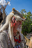 A mountain man in period dress with a coyote-skin hat at the Fort Bridger Mountain Man Rendezvous in Wyoming.