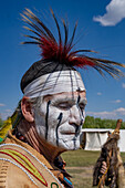 An Amerindian with face paint in period dress at the Fort Bridger Mountain Man Rendezvous in Wyoming.