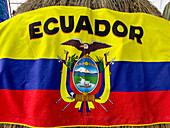 A beach towel made as the national flag of Ecuador in a souvenir shop in the historic center of Quito, Ecuador.