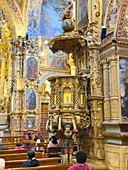The carved wooden pulpit in the nave in the Church of San Francisco in the historic center of Quito, Ecuador.