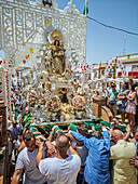 Carrión, Spain, June 19 2025, Bearers climb steep church steps with the Virgen de Consolación, highlighting faith and community during Corpus Christi.