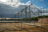 Workers dismantle a tubular fair booth structure after the festivities of the April Fair in Seville, Andalusia, Spain.