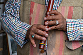 An indigenous Amerindian Quechua man plays the traditional quena or flute in Otavalo, Ecuador.