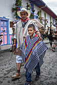 Parade of peasants and locals in traditional clothing in Salento, Quindio, Colombia
