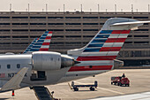 Airliner tails in front of the multi-level parking garage at Phoenix Sky Harbor Airport, Phoenix, Arizona.