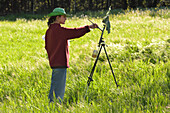 Woman painting in La Herrería park in San Lorenzo de El Escorial, Community of Madrid