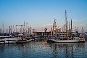 Sailing boats at sunset in Barcelona Port Vell Marina, Barcelona, Spain