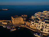 Aerial view of Porto Antico, the historic old port, the Marina, Castello Carlo V and the old town, Monopoli, Italy