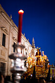Seville, Spain, March 27 2018, During Holy Week in Seville, Nuestro Padre Jesus Cautivo progresses through the Royal Tobacco Factory gardens as evening sets in.