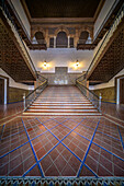 The stunning staircase at Plaza de España showcases intricate tile work and elegant wood, epitomizing Andalusian architecture.