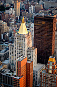 Aerial view of gothic revival style new york life insurance building with its golden leaf rooftop in flatiron district, new york city, united states.