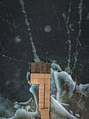 Aerial view of frozen lake with a pier and abstract patterns, Trakai, Trakai, Lithuania.