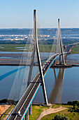 Aerial view of pont de normandie bridge over the river with scenic landscape and blue sky, Normandy, Eure, France.