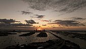 Aerial view of sunrise over PortMiami with vibrant clouds and tranquil water, Downtown, Miami, Florida, United States.