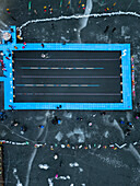 Trakai, Lithuania - 01 March 2025: Aerial view of winter swim competition on a frozen lake with swimmers and spectators, Trakai, Trakai, Lithuania.