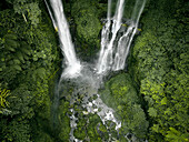 Aerial view of sekumpul waterfall cascading through lush jungle and forest, Sawan, Bali, Indonesia.