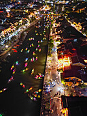 Aerial view of boats adorned with colorful lanterns glide along the river, reflecting the vibrant lights of the ancient town, H?i An, Qu?ng Nam, Vietnam.