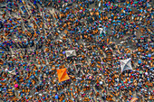 Aerial view of a bustling marketplace teeming with vibrant colors and textures as people trade livestock under the open sky, Mahasthan, Rajshahi Division, Bangladesh.