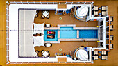 Aerial view of a luxurious cruise ship deck with turquoise pools contrasting against warm wooden tones, inviting relaxation and leisure, Split, Split-Dalmatia County, Croatia.