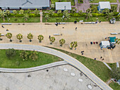Aerial view of the vibrant promenade's patterned pavement contrasting with the lush green of the palm trees and lawns, Batumi, Adjara, Georgia.