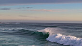 Aerial view of beautiful waves and clouds over the tranquil ocean, Scarborough, Western Cape, South Africa.