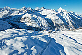 Aerial view of majestic snowy mountains with a rail track, Zermatt, Valais, Switzerland.