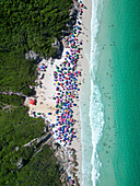 Aerial view of Praia do Atalaia with colorful umbrellas and sandy shore, Arraial do Cabo, Rio de Janeiro, Brazil.