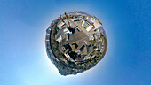 Aerial view of a tiny planet perspective of the historic city center with beautiful buildings and vibrant blue sky, Lenzburg, Aargau, Switzerland.