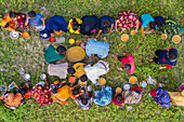 Bogura, Bangladesh - 12 March 2021: Aerial view of vibrant community gathering during majlis public food offering with people sharing a meal on grass, Sekherkola, Bogura, Rajshahi, Bangladesh.