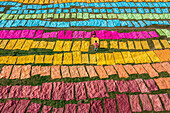 Araihazar, Bangladesh - 04 December 2020: Aerial view of colorful fabrics dyeing process with workers in rows, Duptara, Araihazar, Dhaka, Bangladesh.