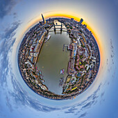Aerial view of a tiny planet perspective of London skyline at sunset featuring the Thames River and Tower Bridge, England, United Kingdom.