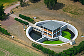 Aerial view of waste water treatment plant with circular structure in rural landscape, Didderse, Niedersachsen, Germany.
