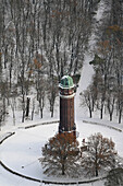 Aerial view of jungfernheide tower surrounded by a serene snowy forest, Berlin, Berlin, Germany.