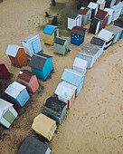 Aerial view of colourful beach huts along sandy coastline, Plage de la Boirie, Saint-Denis-d'Oleron, Charente-Maritime, France.