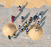 Dhaka, Bangladesch - 16 February 2025: Aerial view of vibrant rice mill activity with children and people engaged in daily life, Dhaka, Dhaka, Bangladesh.