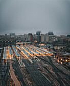Aerial view of the modern Estacion tren Chamartin with busy railway tracks and city lights at nightfall, Madrid, provincia de Madrid, Spain.