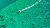 Aerial view of abstract boats over turquoise ocean and reef, Phi Phi, Krabi, Thailand.